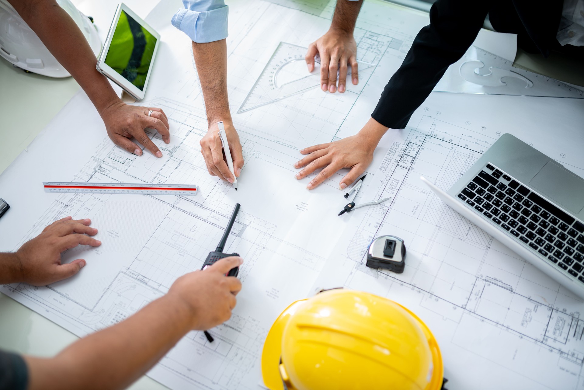 Team of engineers gathers for a meeting to discuss a new project. They collaborate, exchange ideas, and review plans, working together to create innovative solutions